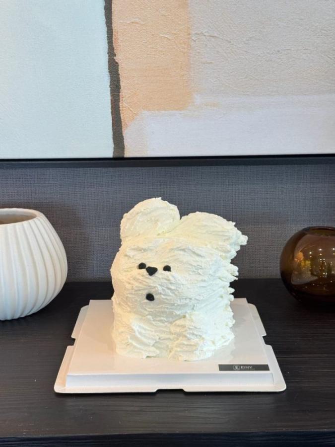 Fluffy white puppy cake piped in soft cream