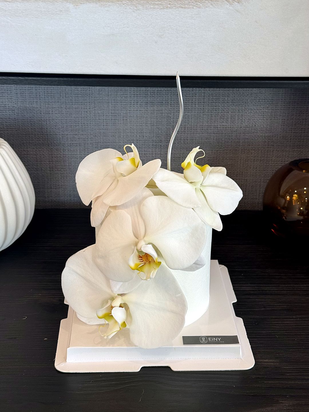 White orchid cake photographed in the studio